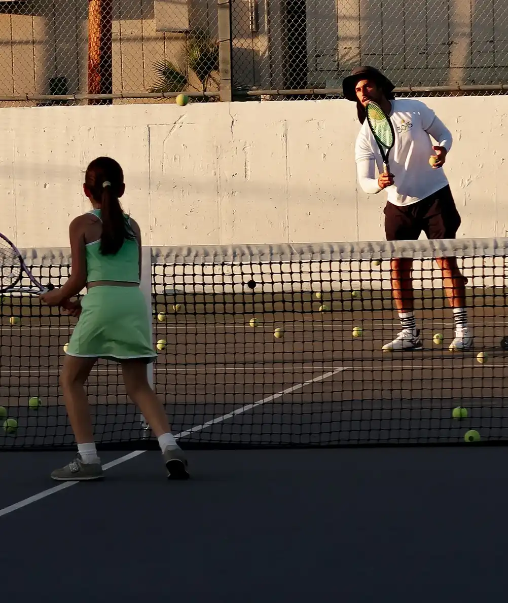 Tennis coaching plans and memberships in Glendale featuring a coach instructing players on court with pricing tiers and program options banner image