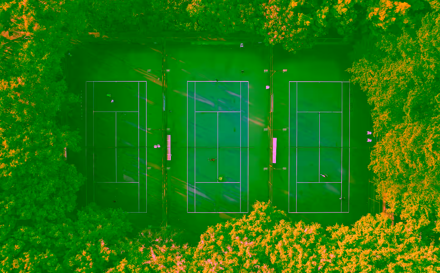 Tennis player on a green court holding a racket