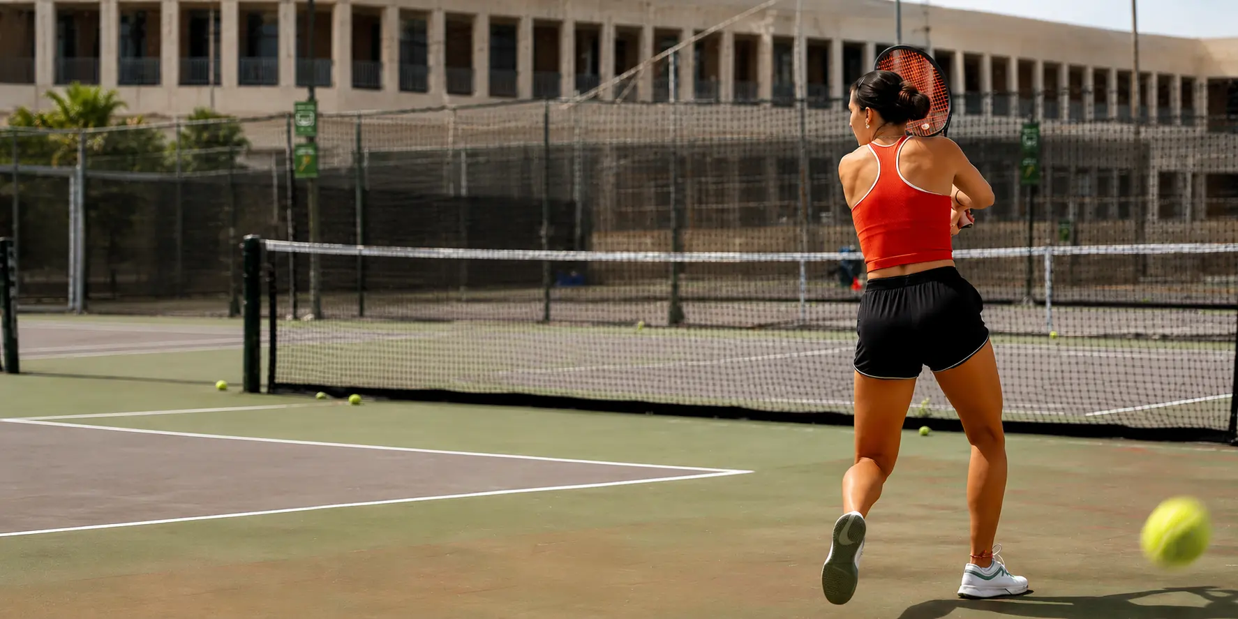Senior tennis players in Glendale enjoying a doubles match on an outdoor tennis court banner image